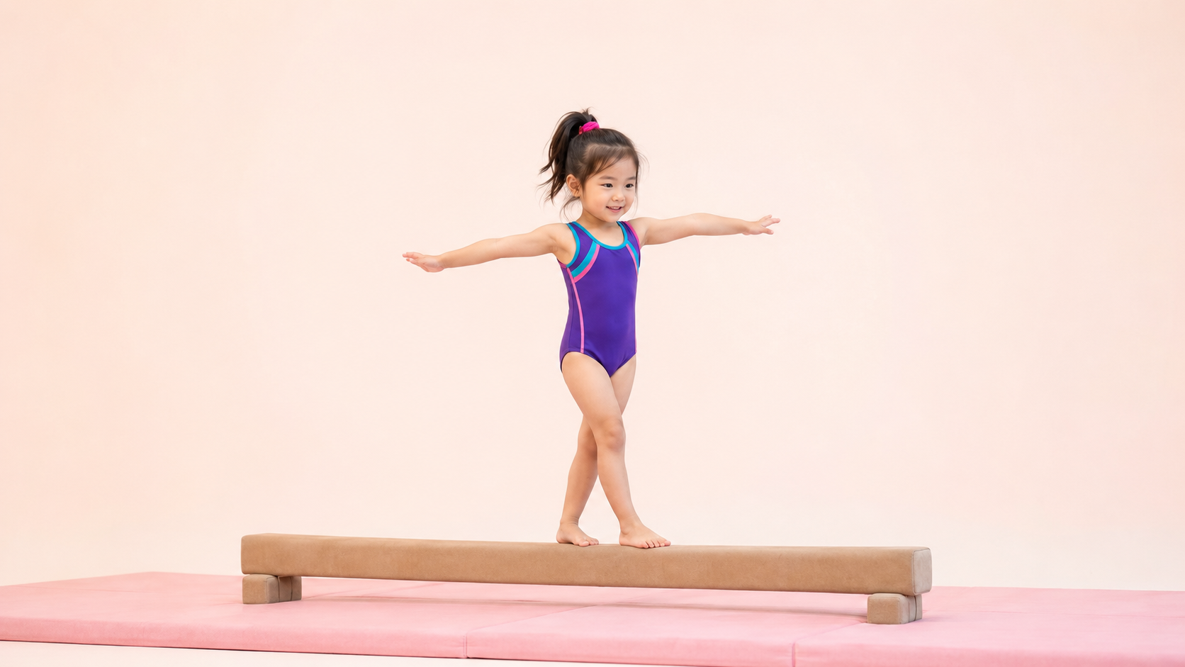 A young girl balancing on a low beam