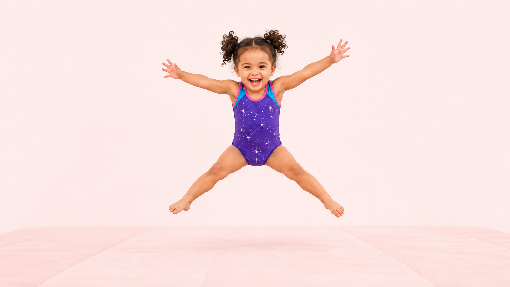 A young girl enjoying a star jump